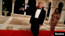 President Donald Trump and first lady Melania Trump arrive for a New Year's Eve party at his Mar-a-Lago club in Palm Beach, Florida, U.S. Dec. 31, 2017.