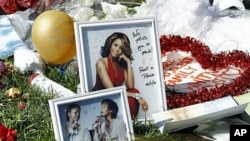 A makeshift memorial to Whitney Houston is seen in front of The Beverly Hilton hotel in Beverly Hills, California, February 17, 2012.