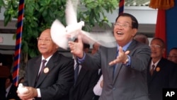 Cambodia's Prime Minister Hun Sen releases a dove during the celebrations of the 65th anniversary of the ruling Cambodian People's Party in Phnom Penh, Cambodia, Tuesday, June 28, 2016. Several hundreds of supporters participated in the celebration. (AP P