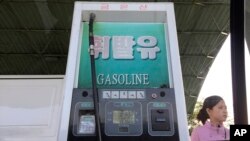 FILE - A gas attendant waits by a pump at a gas station in Pyongyang, North Korea, April 26, 2017. While world attention has focused on Kim Jong Un’s recent missile tests, a surge in gasoline prices that has hit Pyongyang is showing no signs of letting up.