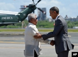 President Barack Obama, right, shakes hands with Philippines Minister of National Defense Voltaire Gazmin after arriving at Ninoy Aquino International Airport in Manila, Philippines, Tuesday, Nov. 17, 2015.