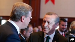 Turkish Prime Minister Tayyip Erdogan, right, talks with EU enlargement commissioner Stefan Fuele, Istanbul Conference of the Ministry For EU Affairs, Istanbul, June 7, 2013.