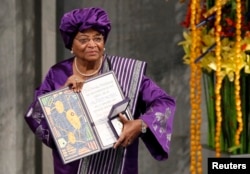 FILE - Nobel Peace Prize winner Liberian President Ellen Johnson Sirleaf poses with her diploma and medal after receiving the prize at the award ceremony in Oslo, Dec. 10, 2011.