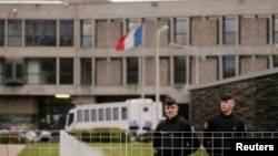 FILE - French gendarme stand in front of the entrance of the Fleury-Merogis prison near Paris, France. The prison is home to Salah Abdeslam.