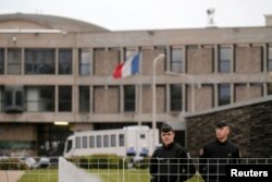 FILE - French gendarme stand in front of the entrance of the Fleury-Merogis prison near Paris, France, Apr. 27, 2016. The prison is home to Salah Abdeslam, the sole surviving suspect in Paris terror attacks.