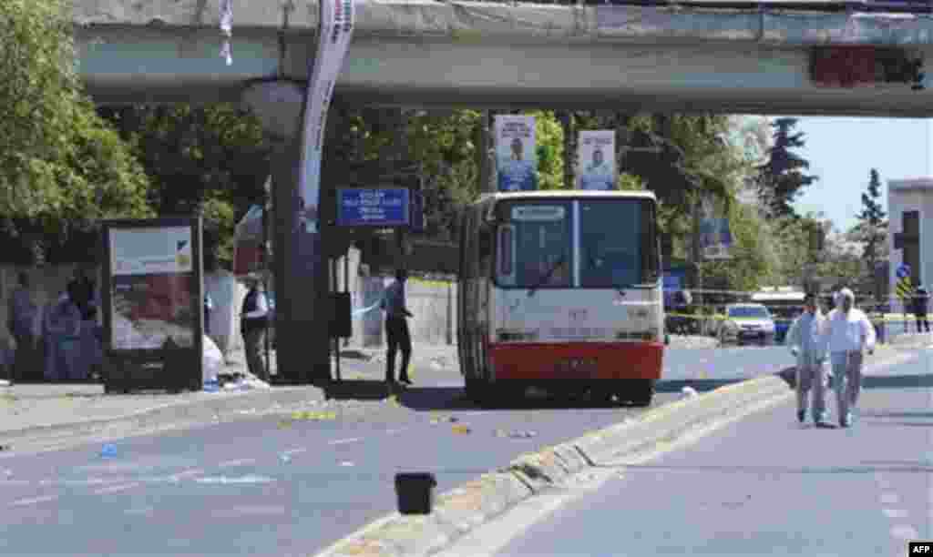 Forensic experts work at the scene after a bomb exploded at a bus stop during rush hour in Istanbul, Turkey, Thursday, May 26, 2011. Seven people were injured as several ambulances rushed to the scene on a multi-lane thoroughfare in a busy commercial sect