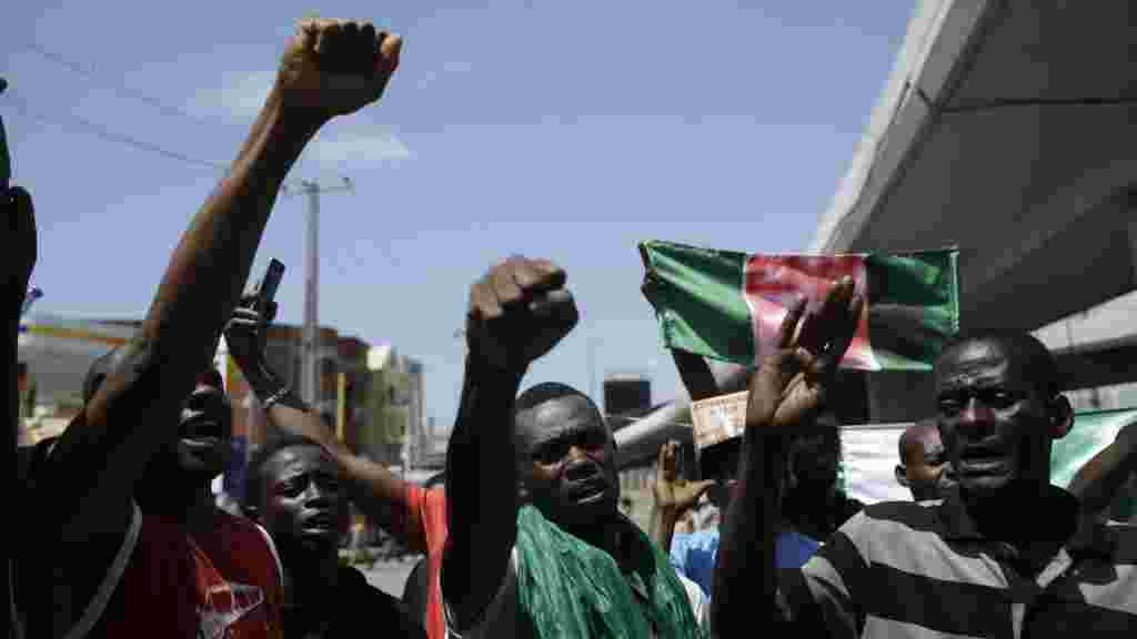 People demonstrate on the street to protest against police in Legas.