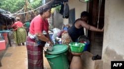 Residents try to salvage their belongings in the Paquite district of Pemba, April 29, 2019, as Cyclone Kenneth hit northern Mozambique, destroying thousands of homes.