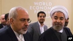 Iran's President Hassan Rouhani (r), and and his Foreign Minister Mohammad Javad Zarif, at the World Economic Forum in Davos, Jan. 22, 2014. 