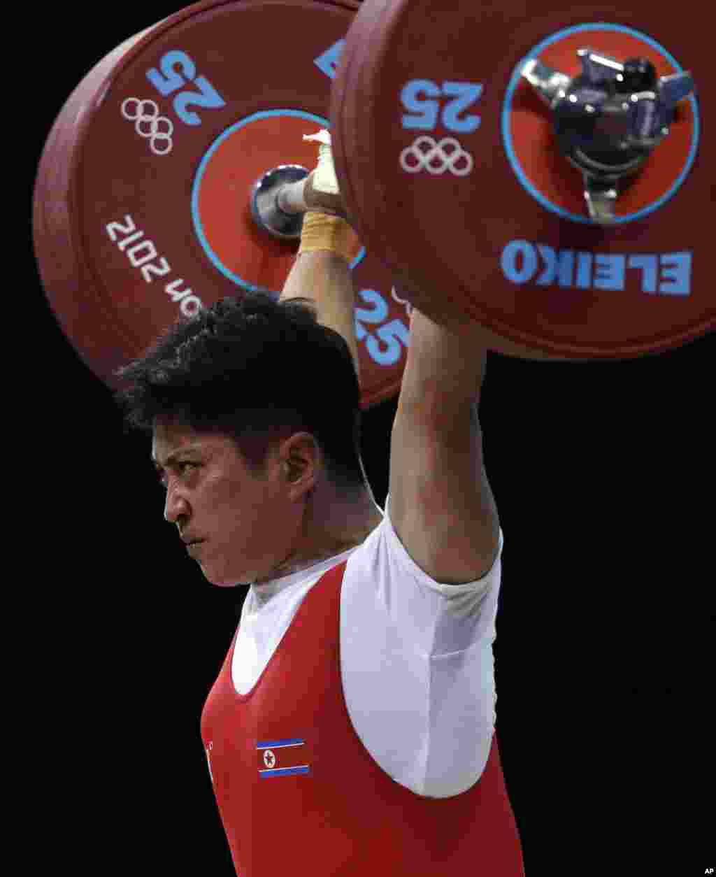 Kim Kum Sok of North Korea competes during the men&#39;s 69-kg weightlifting competition at the 2012 Summer Olympics, July 31, 2012.