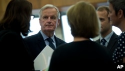 EU chief Brexit negotiator Michel Barnier, second left, talks to other European Commissioners before a weekly meeting at the European Commission headquarters in Brussels, Wednesday, Oct. 10, 2018. 