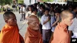 Cambodian Buddhist monks and villagers line up before the second trial to the top leaders of Khmer Rouge at the outside the court hall of the U.N.-backed war crimes tribunal. Now old and infirm, four of the top surviving members of the Khmer Rouge's rulin