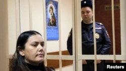 Gulchekhra (Gyulchekhra) Bobokulova, a nanny suspected of murdering a child in her care, sits inside a defendants' cage as she attends a court hearing in Moscow, Russia, March 2, 2016. 