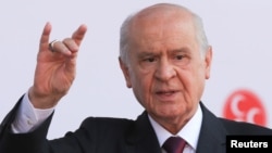 FILE - Devlet Bahceli, leader of Nationalist Movement Party (MHP), gestures as he attends his election rally in Ankara, Turkey, June 23, 2018.