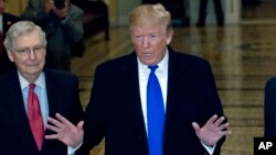 President Donald Trump accompanied by Senate Majority Leader Mitch McConnell of Ky., left, arrives for a Senate Republican policy lunch on Capitol Hill in Washington, March 26, 2019.