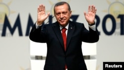 Turkey’s Prime Minister Tayyip Erdogan greets members of the AK Party (AKP), which named him as its presidential candidate in Ankara, July 1, 2014.