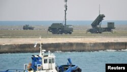 A Patriot Advanced Capability-3 missiles unit (R) is seen as a boat sails past in Ishigaki on Japan's southern island of Ishigaki Island, Okinawa prefecture, December 10, 2012.
