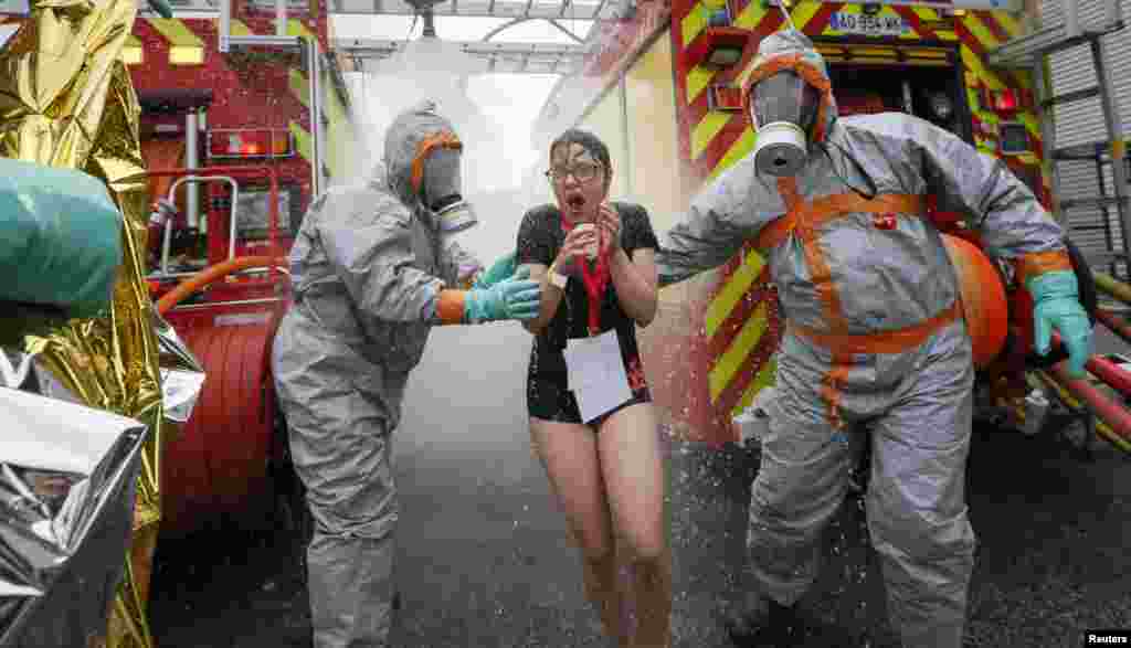 French firemen wearing chemical protective suits take part in a mock chemical attack exercise at the Geoffroy Guichard stadium in Saint-Etienne in preparation of security measures for the UEFA 2016 European Championship.