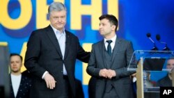 Ukrainian President Petro Poroshenko, left, and Ukrainian presidential candidate and popular comedian Volodymyr Zelenskiy attend debates at the Olympic stadium in Kiev, Ukraine, April 19, 2019.