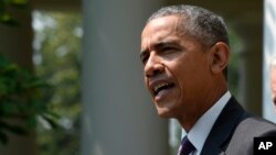 President Barack Obama, accompanied by Vice President Joe Biden, speaks in the Rose Garden of the White House in Washington, July 1, 2015. 