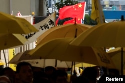 Pro-China supporters wave Chinese national flag as pro-democracy supporters hold yellow umbrellas to support leaders of Occupy Central activists outside the court, in Hong Kong, China, April 24, 2019.