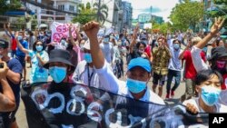 FILE - In this May 12, 2021, photo, anti-coup protesters march during a demonstration in Yangon, Myanmar. 