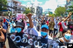 FILE - In this May 12, 2021, photo, anti-coup protesters march during a demonstration in Yangon, Myanmar.