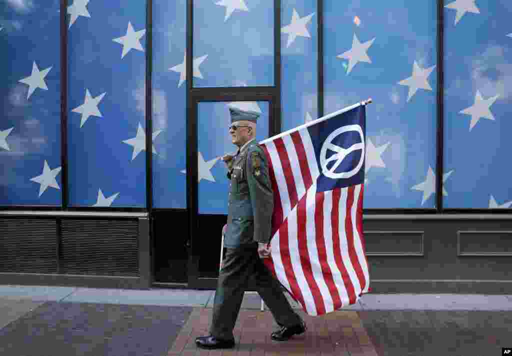 A protester carrying a peace flag walks in downtown Cleveland, Ohio, where the Republican National Convention is going to be held on July 18.