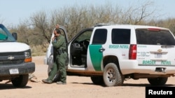 U.S. Customs and Border Protection agents talk near the U.S.-Mexico border that crosses the Tohono O'odham reservation in Chukut Kuk, Arizona, April 6, 2017.