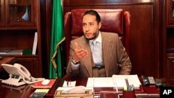 Saadi Gaddafi, a son of Libyan leader Muammar Gaddafi, speaks during a news conference at his office in Tripoli, January 31, 2010 (file photo).