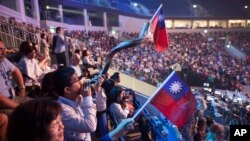 Evangelical Christians wave Taiwanese flags and another blows a shofar during a gathering in Jerusalem. Thousands of evangelical Christians from more than 80 countries descended upon Jerusalem this week to profess their love for the Jewish state, Sept. 29