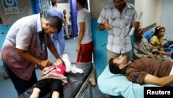 Patients are treated in Shifa hospital in Gaza City, July 18, 2014.