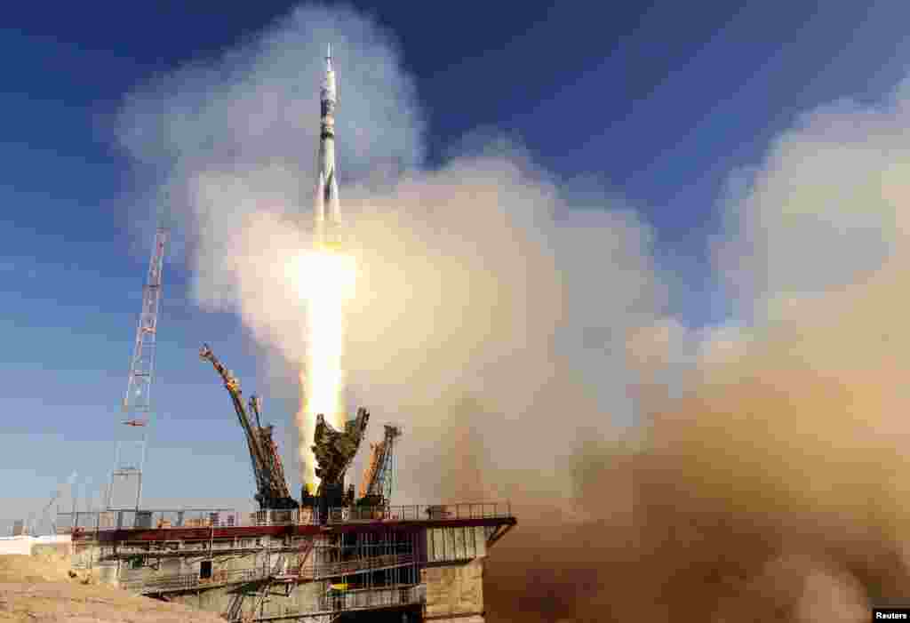 The Soyuz TMA-11M spacecraft decorated with the 2014 Sochi Winter Olympic Games logo and a blue-and-white snowflake pattern, blasts off from the launch pad at the Baikonur cosmodrome, Nov. 7, 2013. 