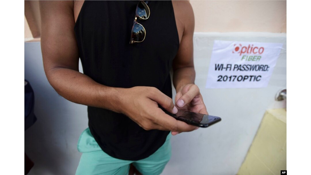 A man stands at a Wi-Fi hot spot in the aftermath of Hurricane Maria with many cellphone towers down in San Juan, Puerto Rico, Sept. 24, 2017.