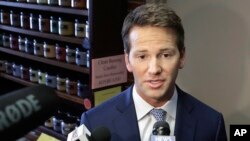 FILE - Former U.S. Rep. Aaron Schock, R-Ill., speaks to reporters in Peoria, Ill., Feb. 6, 2015. Schock has been charged in the 24-count indictment with fraud and theft. 