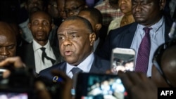 FILE - Former DRC warlord Jean-Pierre Bemba (C), speaks to the press after filing to run as a candidate in the country's next presidential election Dec. 23, at election commission offices, in Kinshasa, DRC, Aug. 02, 2018. 