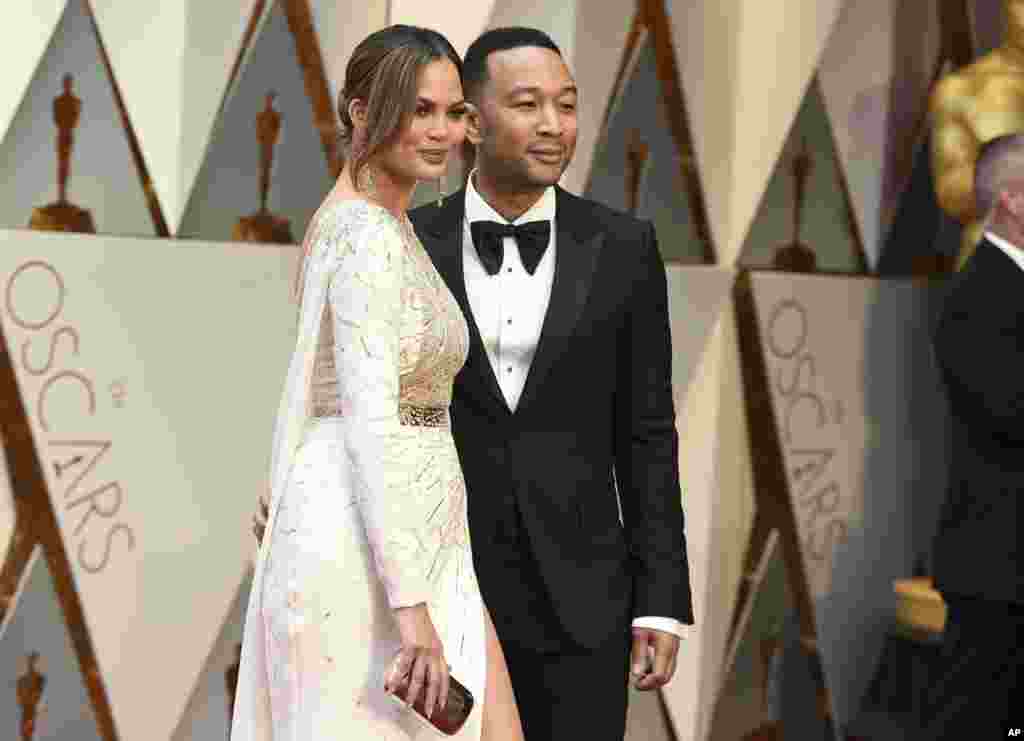 Chrissy Teigen, left, and John Legend arrive at the Oscars on Feb. 26, 2017, at the Dolby Theatre in Los Angeles. 