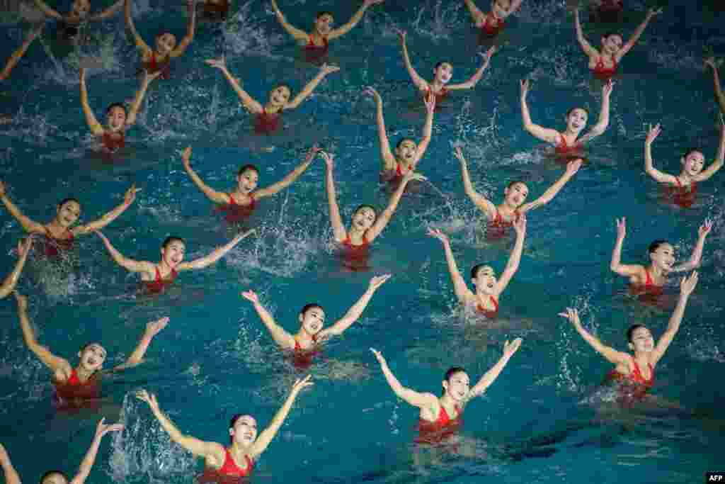 Swimmers perform in a synchronized swimming gala event celebrating late North Korean leader Kim Jong Il, in Pyongyang.