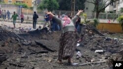 A woman cries at the scene of one of the explosion sites