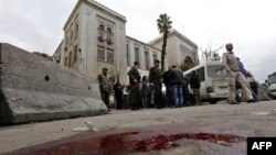 Syrian security forces cordon off the area following a reported suicide bombing at the old palace of justice building in Damascus, March 15, 2017.