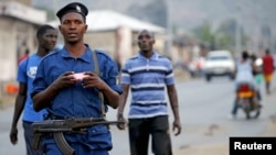 FILE - Burundi police patrol the streets in the capital Bujumbura after the results of the presidential elections were released, July 24, 2015.