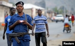 FILE - Burundi police patrol the streets of Musaga district in the capital Bujumbura after the results of the presidential elections were released, July 24, 2015.