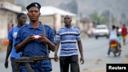 FILE - Burundi police patrol the streets of Musaga district in the capital, Bujumbura, after the results of the presidential elections were released, July 24, 2015.