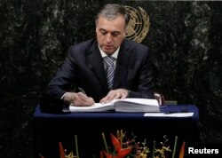 FILE - Montenegro President Filip Vujanovic signs the Paris Agreement on climate change at the United Nations Headquarters in New York, April 22, 2016.