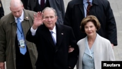 FILE - Former US President George W. Bush and wife Laura Bush arrive near the east front steps of the Capitol Building before President-elect Donald Trump is sworn in at the 58th Presidential Inauguration on Capitol Hill in Washington.