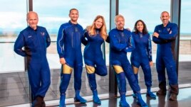 This image provided by Virgin Galactic shows, from left: Chief Pilot Dave Mackay, Lead Operations Engineer Colin Bennett, Chief Astronaut Instructor Beth Moses, Founder of Virgin Galactic Richard Branson, Vice President of Government Affairs and Research Operations Sirisha Bandla and pilot Michael Masucci. (Virgin Galactic via AP)