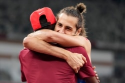 FILE - In this Aug. 1, 2021, file photo, Gianmarco Tamberi, of Italy, embraces fellow gold medalist Mutaz Barshim, of Qatar, after the final of the men's high jump at the 2020 Summer Olympics in Tokyo.