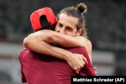 FILE - In this Aug. 1, 2021, file photo, Gianmarco Tamberi, of Italy, embraces fellow gold medalist Mutaz Barshim, of Qatar, after the final of the men's high jump at the 2020 Summer Olympics in Tokyo.