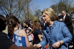 FILE - Democratic U.S. Presidential candidate Hillary Clinton talks to supporters during campaign stop outside of a polling station in Raleigh, North Carolina, March 15, 2016.