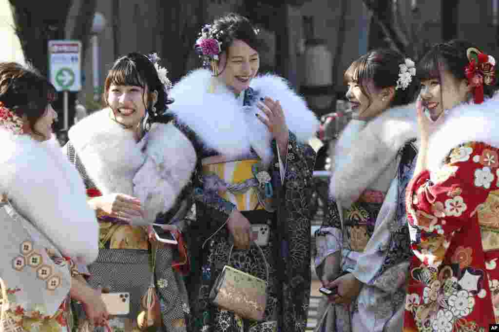 Kimono-clad women who celebrate their 20th birthday gather following a Coming of Age ceremony at Toshimaen amusement park in Tokyo, Japan, on Coming of Age Day.